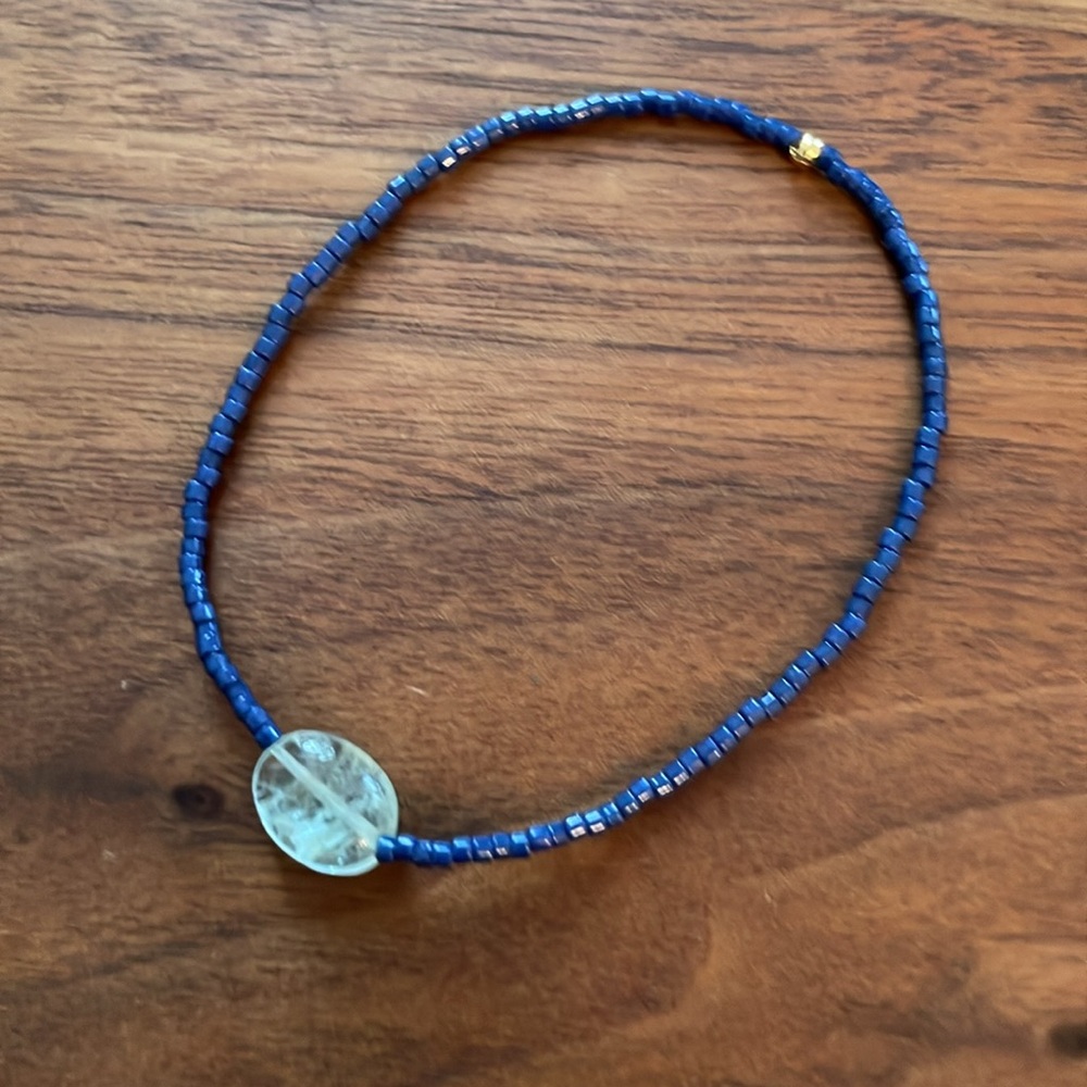Aquamarine gemstone, gold plated bead and Japanese glass bead stretch bracelet.
